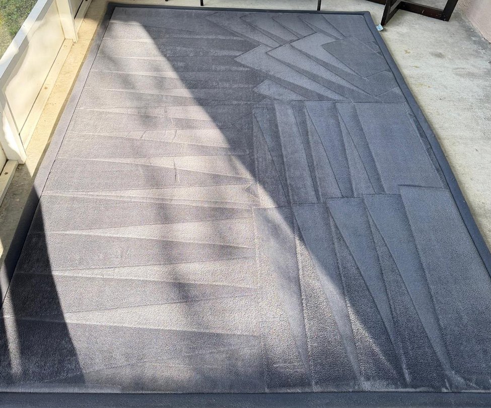 Gray area rug on a screened patio after professional deep cleaning